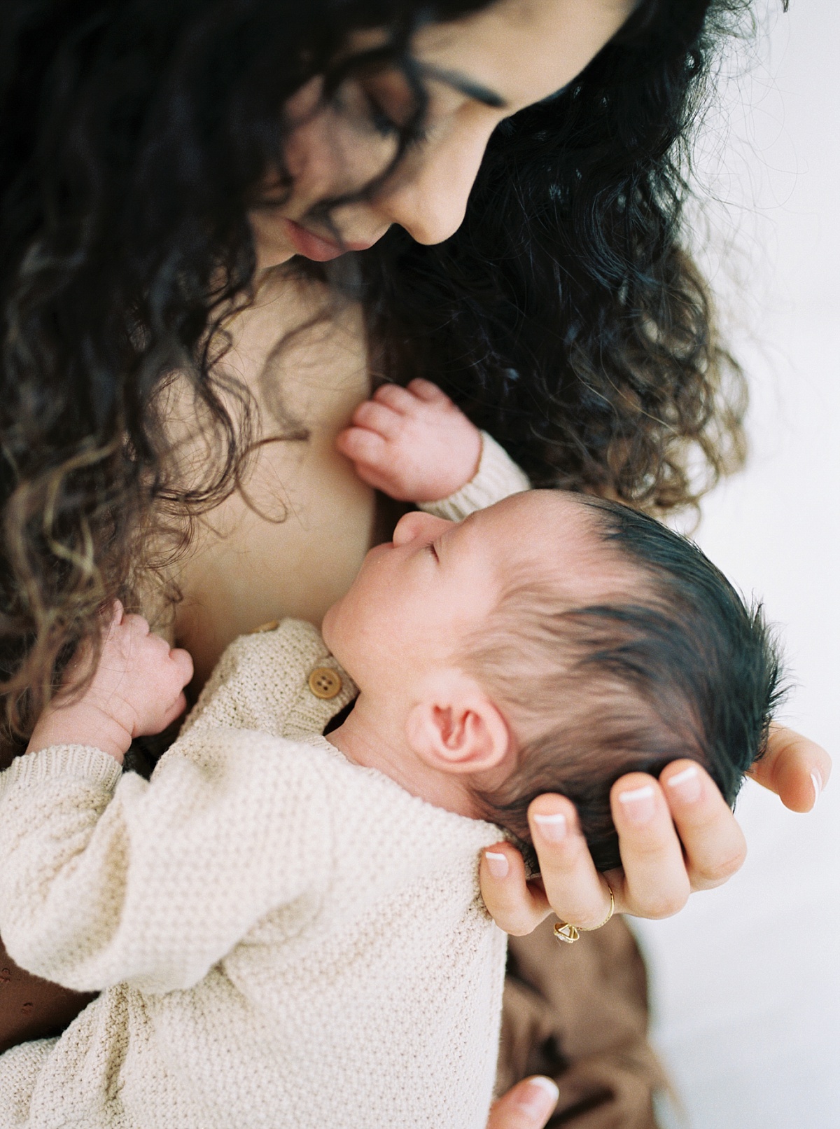 film image of mom holding newborn on chest
