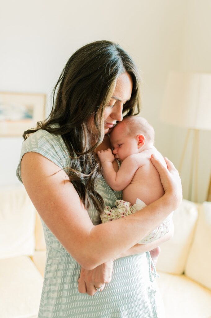 Mother snuggles newborn baby by Portland Newborn Photographer Emilie Phillipson Photography. 
